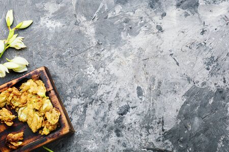 Fried yucca flowers on greyの写真素材