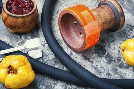 Oriental smoking shisha.Hookah bowl and tobacco.Details of Turkish nargile.Kalian tobacco with apple aroma and quince.の写真素材