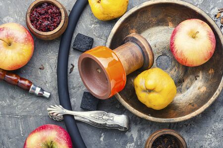 Oriental smoking shisha.Hookah bowl and tobacco.Details of Turkish nargile.Kalian tobacco with apple aroma and quince.の写真素材