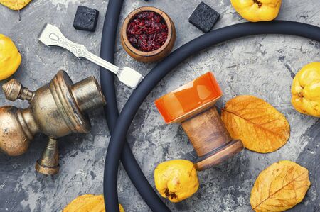 Preparation of a smoking hookah.Oriental hookah with a fruit aroma.Hookah on an apple.の写真素材