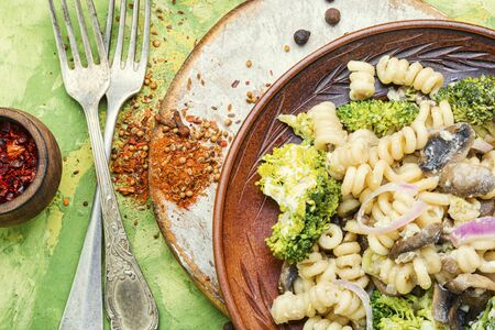 Baked broccoli and pasta with mushrooms.Italian foodの写真素材