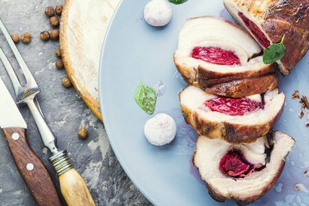 Baked pork meat stuffed with cherries.Baked pork.の写真素材