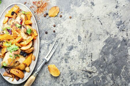 Baked meat with pumpkin and quince.Chicken stew with pumpkin.Copy spaceの写真素材