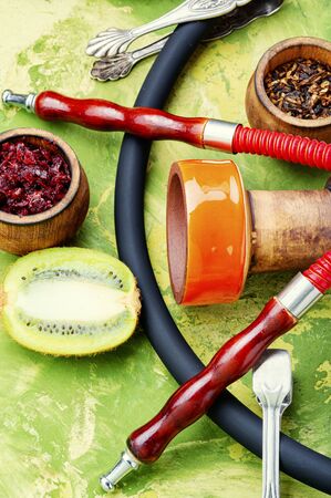 Arabic smoking hookah with taste of kiwi.Fruit shisha tobacco. Tobacco with taste of kiwi.Oriental hookaの写真素材