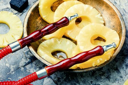 Oriental smoking hookah. Hookah tobacco with aroma of ananas.Pineapple hookah.の写真素材