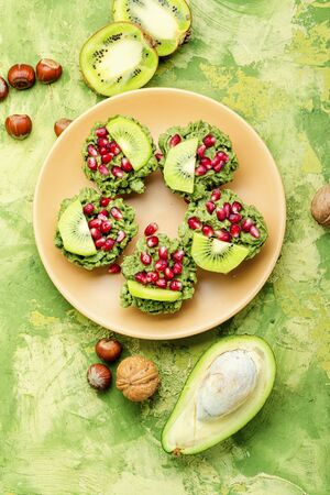 Diet avocado cupcakes garnished with kiwi and pomegranate.American fairy cakeの写真素材
