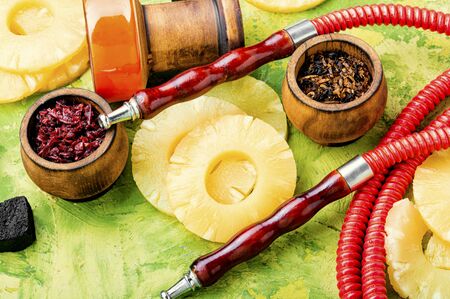 Arabian smoking shisha. Hookah tobacco with aroma of ananas.Pineapple hookah.
