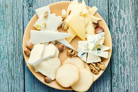 Delicious cheese on the wooden table.Different kinds of cheeses