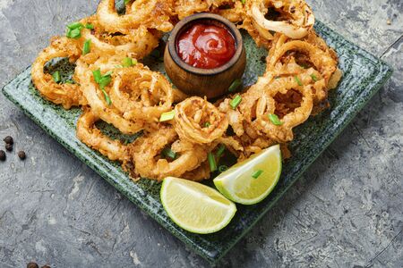 Crunchy deep fried squid rings in batter.Fast foodの写真素材
