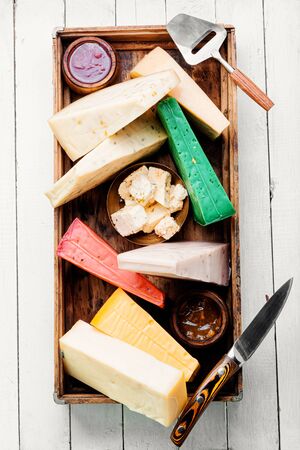 Various kind of cheese served in wooden box.Slices of cheeseの写真素材