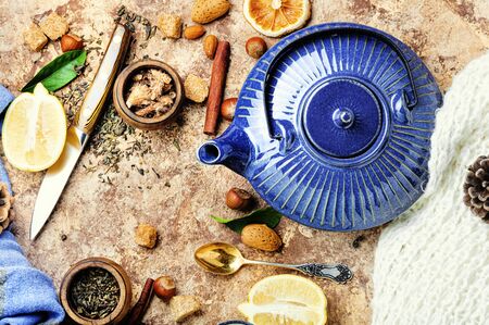 Teapot with tea.Natural ingredients for tea.Porcelain blue teapot.Useful tea with lemon.の写真素材