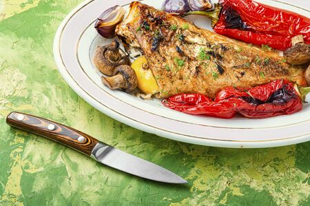 Red sea bass baked with mushrooms and red pepper.Fish in roasted vegetables.Healthy food