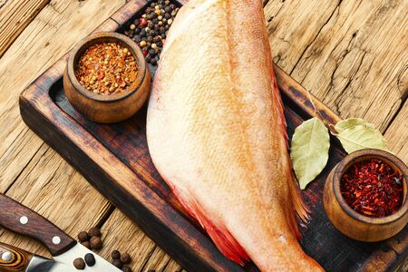 Whole raw fresh red perch or seabass.Raw fish on wooden background.Fresh fish seabass.の写真素材