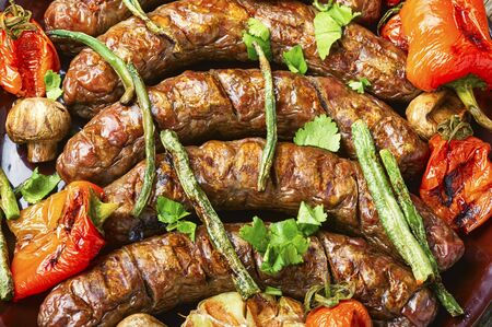 Delicious german sausages with grilled mushrooms and tomatoes.BBQ with sausageの写真素材