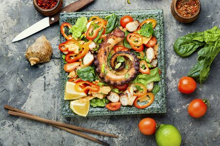 Thai salad with grilled octopus and fresh vegetables.の写真素材