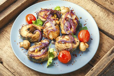 Roasted mackerel with tasty grilled vegetables on a plate.Roast fish.Homemade grilled fishの写真素材