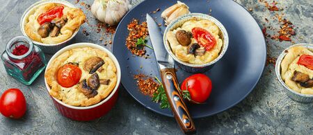 Appetizing garlic tart with tomato,mushrooms and feta cheeseの写真素材