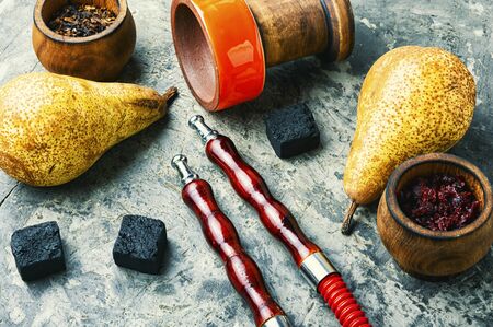 Asian tobacco hookah.Oriental smoking shisha with tobacco.Fruit tobacco with pear.Hookah smoking...