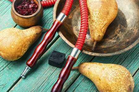 Asian tobacco hookah.Oriental smoking shisha with tobacco.Fruit tobacco with pear.Hookah smoking...