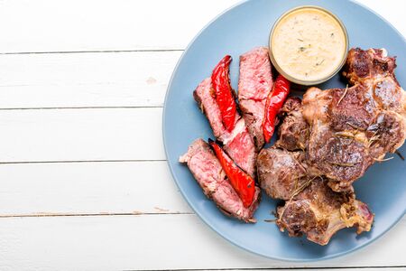 Grilled sliced beef steak with sauce on plateの写真素材