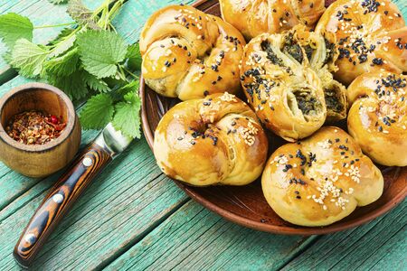 Homemade rustic nettle and spinach buns.Fresh baked buns with herbsの写真素材