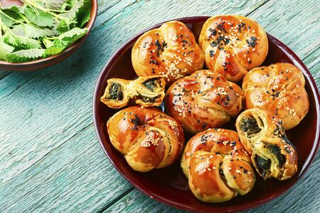 Homemade rustic nettle and spinach buns.Fresh baked buns with herbsの写真素材