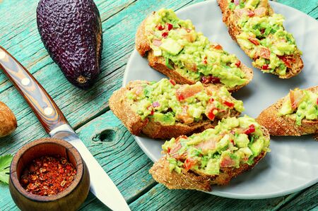 Traditional mexican sauce guacamole and avocado sandwiches