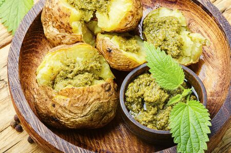 Baked potatoes stuffed with herbs and nettle leavesの写真素材