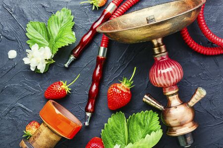 Oriental smoking hookah with strawberry tobacco. Berry hookah tobacco.の写真素材