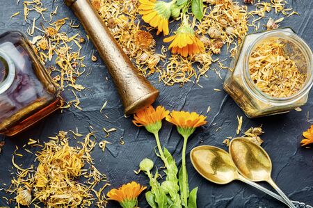 Medicinal tincture of calendula flowers, medicinal wild herbs.の写真素材