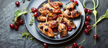 Fried chicken wings in spicy cherry sauce.Grilled chicken, fast food.の写真素材