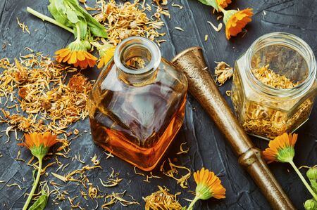 Medicinal tincture of calendula flowers, medicinal wild herbs.の写真素材