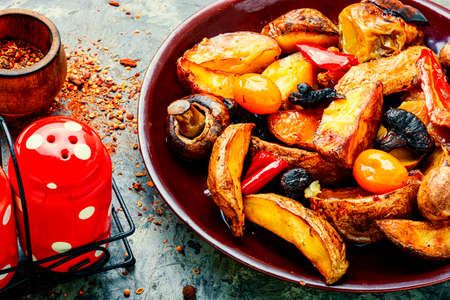 Plate with delicious fried homemade potatoes with mushroomsの写真素材