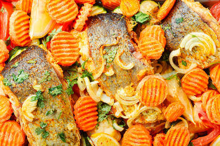 Baked fish steaks with grilled vegetables.Food background, close up