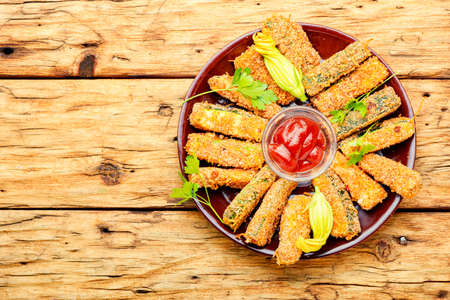 Baked zucchini sticks with sauces, roasted zucchini. Breaded fried zucchini.Zucchini sticks in breadcrumbsの写真素材