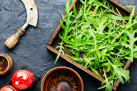 Green fresh rucola or arugula leaf in wooden box. Rocket saladの写真素材