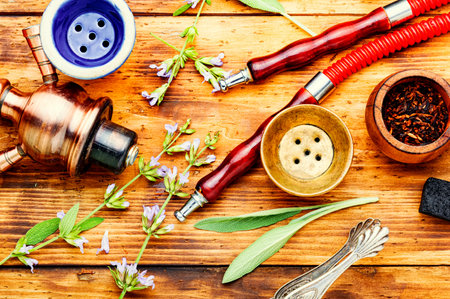 Details of a smoking shisha.Hookah on herbs. Hookah tobacco with sage flavor.の写真素材