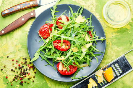 Appetizing Italian salad with arugula, sun-dried tomatoes and cheese.Summer saladの写真素材