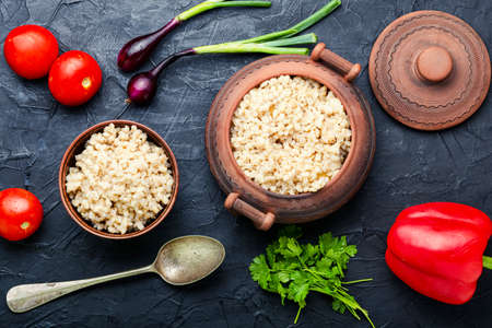 Vegetarian crumbly pearl barley porridge with vegetablesの写真素材