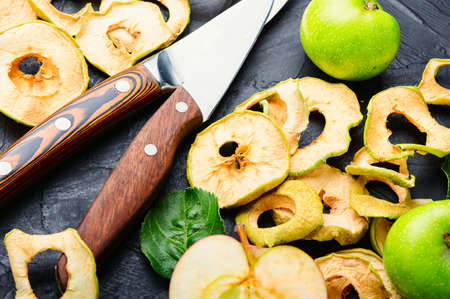Sun-dried apple slices or apple chips and fresh apple