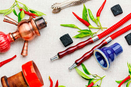 Oriental hookah with tobacco aroma of red hot pepper. Hookah with chilli pepper flavor.