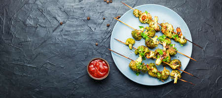 Vegetable kebab from broccoli cabbage.Fried cabbage on wooden skewersの写真素材