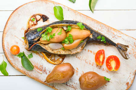 Baked mackerel fish stuffed with autumn pear.Grilled mackerel with pearsの写真素材