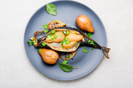 Baked mackerel fish stuffed with autumn pear.