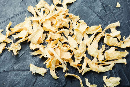 Slices of dry ginger and raw rhizome gingerの写真素材