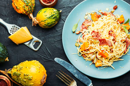 Pasta or spaghetti with pumpkin and bacon.Pasta carbonara.Seasonal autumn foodの写真素材