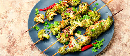 Vegetable diet kebab from broccoli cabbage on plateの写真素材