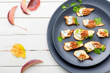 Dry pear, blue cheese and walnut appetizer. Seasonal snack.の写真素材