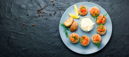 Appetizer homemade cod roe fish meatballs. Fish cutlets decorated with salmon.の写真素材