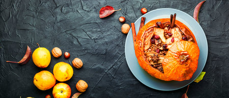Pumpkin stuffed with granola and dried fruits.Popular autumn dessert.Copy spaceの写真素材